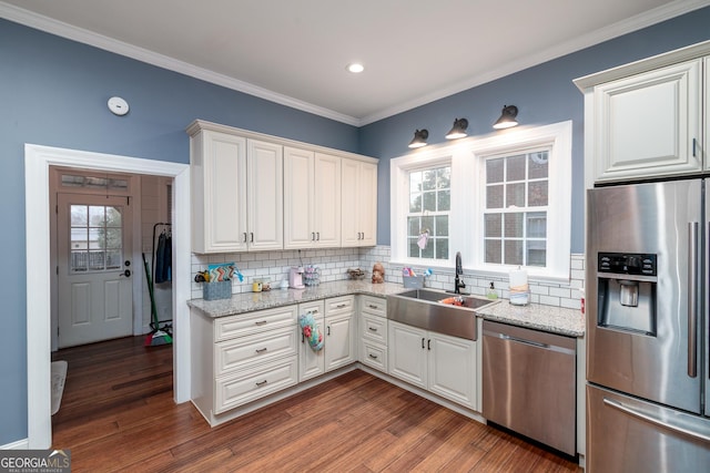 kitchen with appliances with stainless steel finishes, sink, dark hardwood / wood-style flooring, and white cabinets