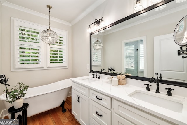 bathroom featuring separate shower and tub, hardwood / wood-style flooring, vanity, and ornamental molding