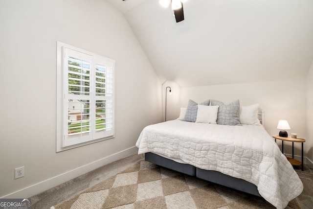 carpeted bedroom with vaulted ceiling and ceiling fan