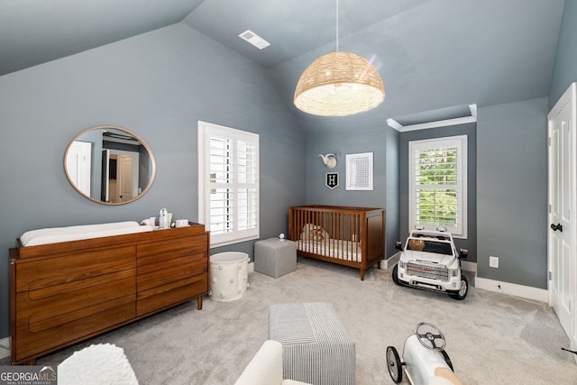 carpeted bedroom featuring multiple windows and vaulted ceiling