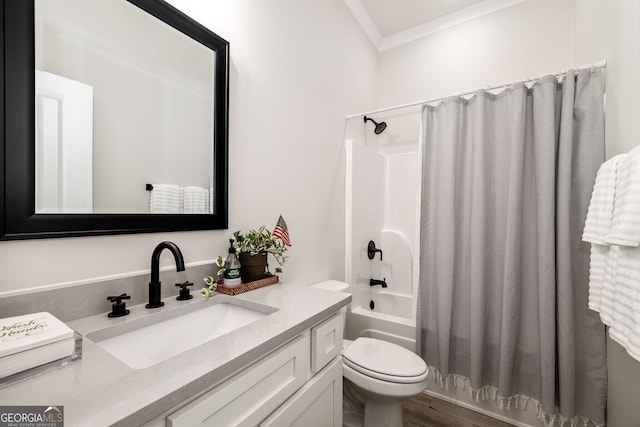 full bathroom with hardwood / wood-style floors, vanity, shower / tub combo, toilet, and ornamental molding