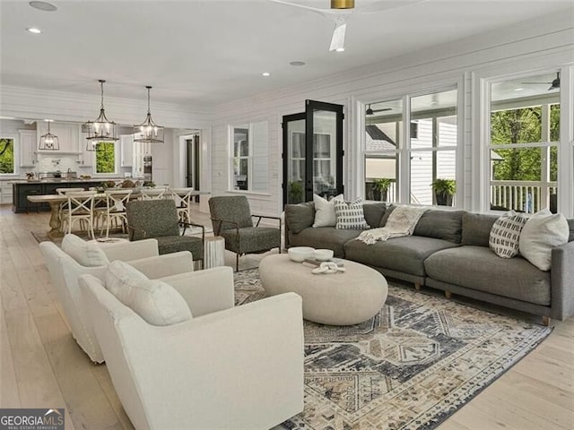 living room with light hardwood / wood-style flooring and an inviting chandelier