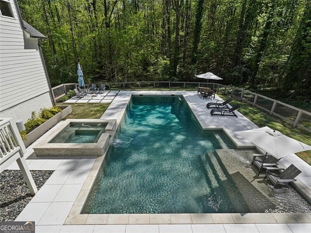 view of swimming pool with a patio and an in ground hot tub