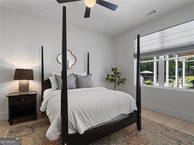 bedroom with hardwood / wood-style floors and ceiling fan