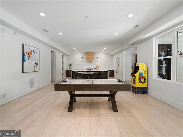 playroom with light hardwood / wood-style flooring