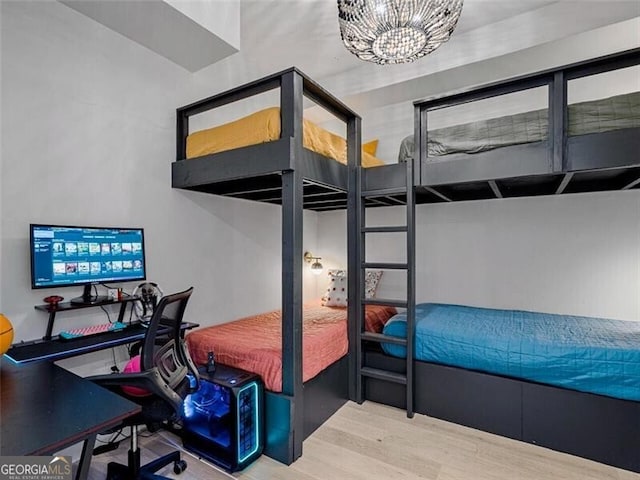 bedroom with an inviting chandelier and wood-type flooring