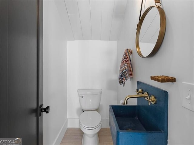 bathroom featuring hardwood / wood-style floors and toilet