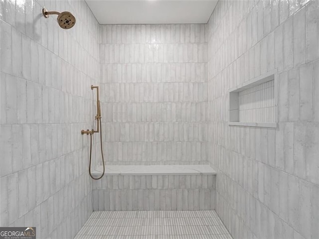 bathroom with tiled shower