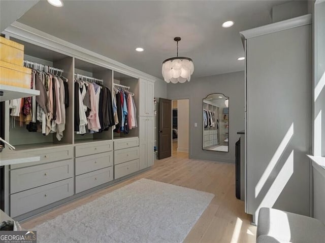 walk in closet featuring light hardwood / wood-style flooring