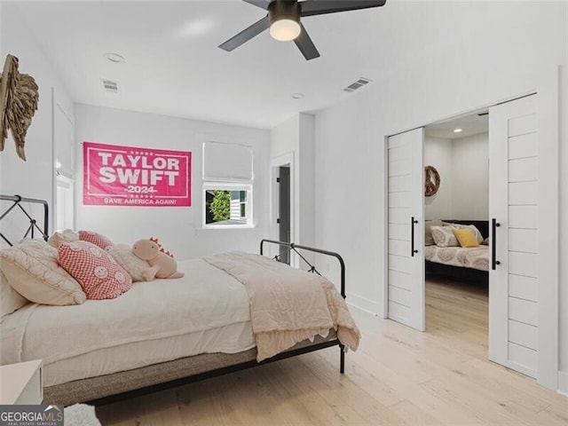 bedroom with ceiling fan and light hardwood / wood-style floors