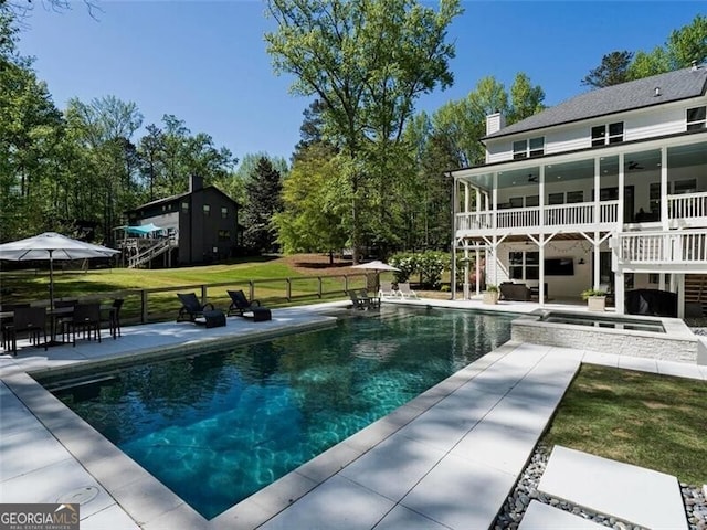 view of pool featuring an in ground hot tub, ceiling fan, a patio, and a lawn