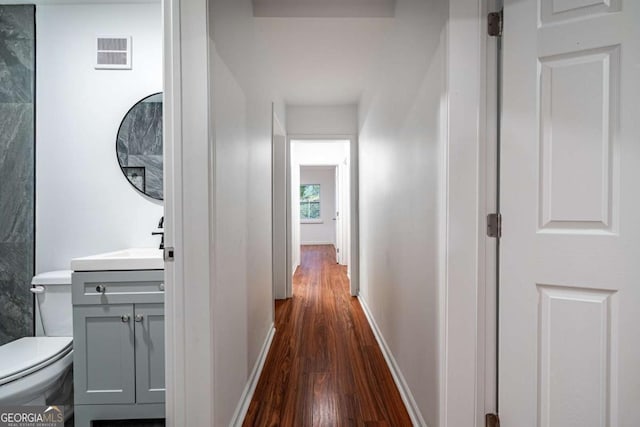 hall featuring sink and dark wood-type flooring