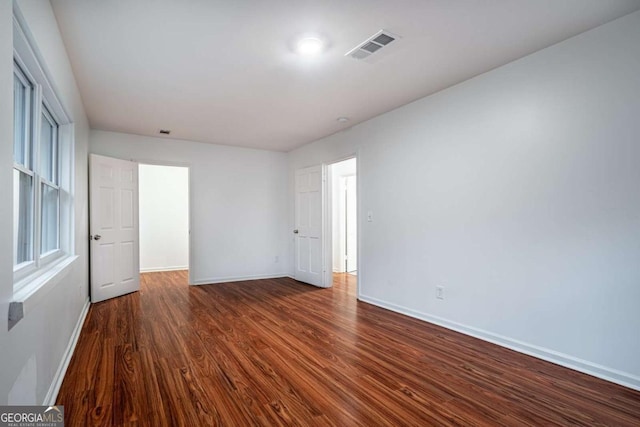 unfurnished bedroom with dark hardwood / wood-style flooring