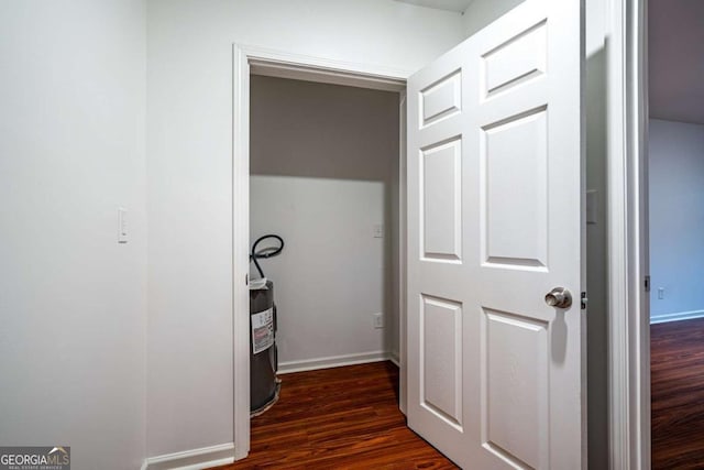 hallway with dark hardwood / wood-style floors