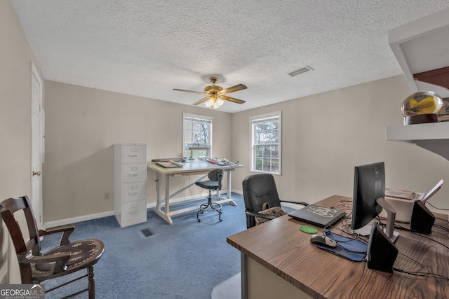 home office featuring carpet floors, a textured ceiling, and ceiling fan