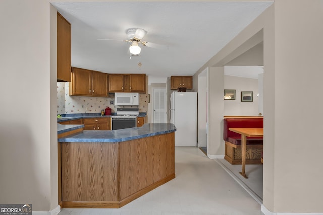 kitchen with white appliances, ceiling fan, and tasteful backsplash