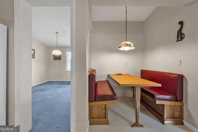 carpeted dining area featuring breakfast area