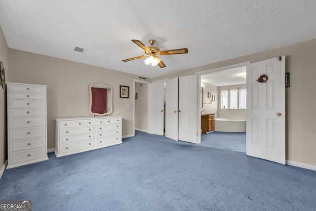 unfurnished bedroom featuring ceiling fan, connected bathroom, carpet flooring, and a textured ceiling