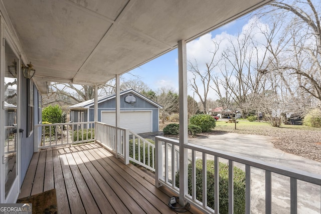 wooden deck with a garage and an outdoor structure