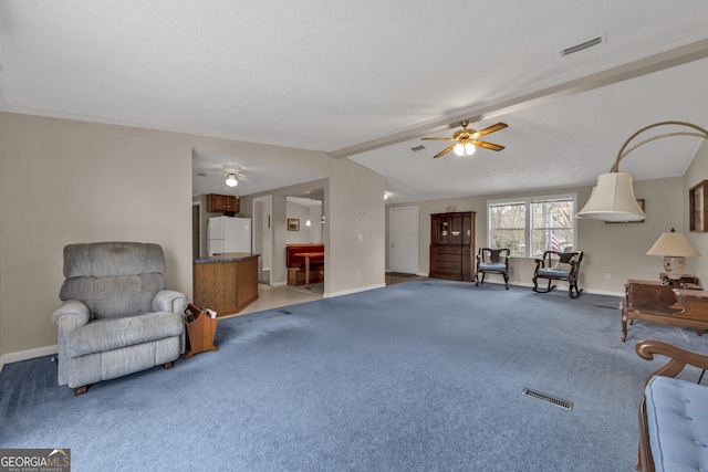 sitting room with ceiling fan, lofted ceiling with beams, and carpet