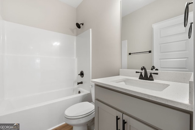bathroom with shower / bathtub combination, vanity, and toilet