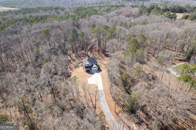 bird's eye view featuring a wooded view