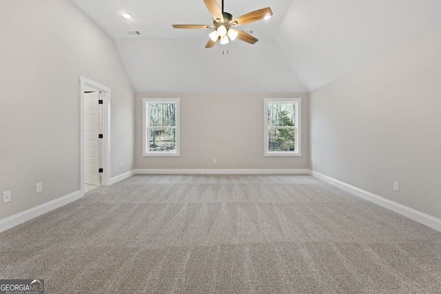 empty room featuring plenty of natural light, ceiling fan, visible vents, and light colored carpet