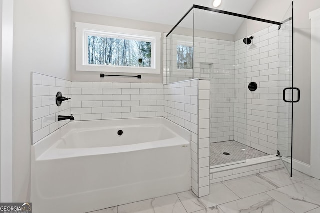 full bath with a garden tub, baseboards, marble finish floor, and a stall shower