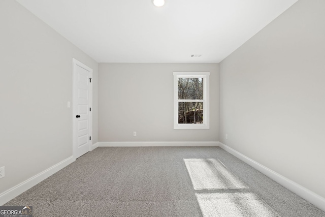 carpeted empty room with baseboards and visible vents
