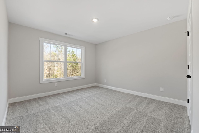 empty room featuring recessed lighting, baseboards, visible vents, and carpet