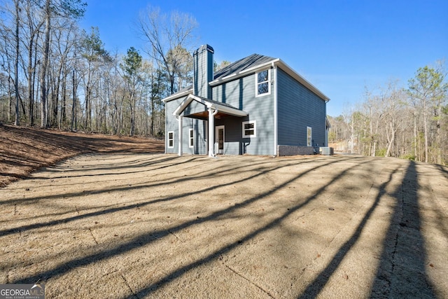 back of property with a chimney
