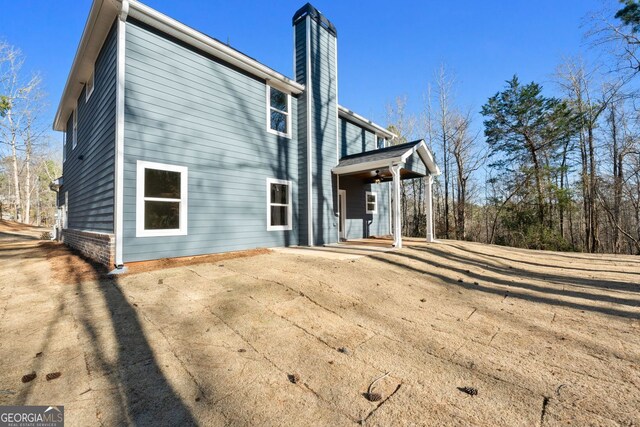 view of side of home with a chimney