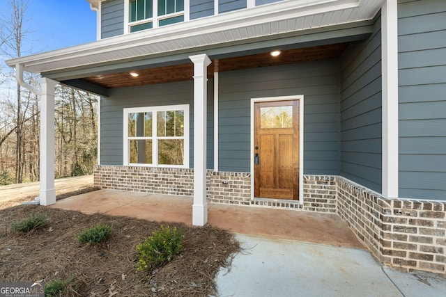 view of exterior entry featuring a porch