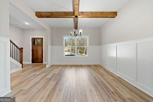 1578 English Rd, Forsyth, GA 31029 - unfurnished dining area with light wood finished floors, a chandelier, a decorative wall, beamed ceiling, and stairs