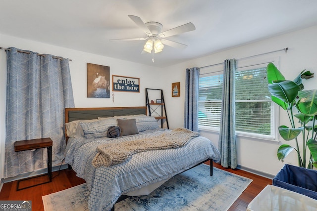 bedroom with ceiling fan and dark wood-type flooring