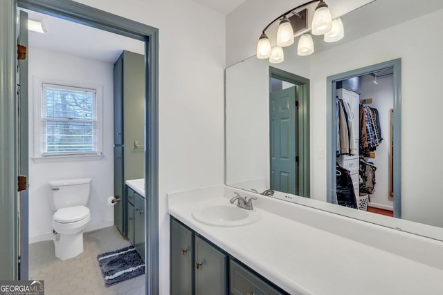 bathroom with vanity, toilet, and tile patterned floors