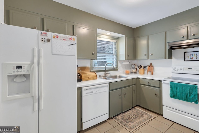 kitchen featuring light tile patterned flooring, sink, and white appliances