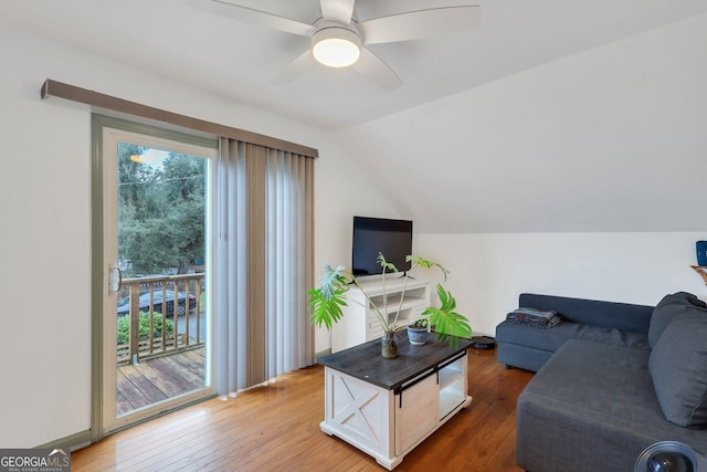 living room with lofted ceiling, hardwood / wood-style floors, and a healthy amount of sunlight