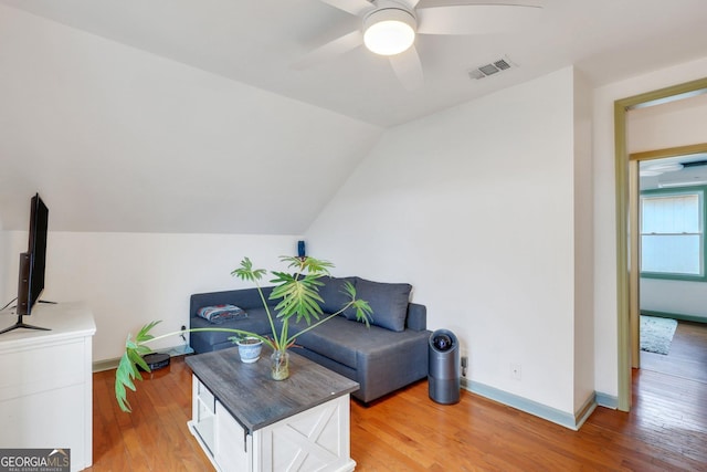 living room featuring ceiling fan, hardwood / wood-style flooring, and lofted ceiling