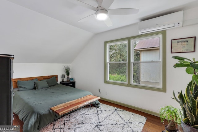 bedroom featuring lofted ceiling, ceiling fan, hardwood / wood-style floors, and a wall mounted air conditioner