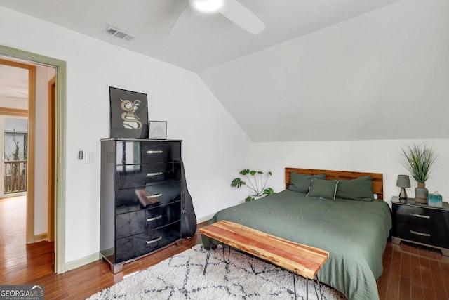 bedroom with hardwood / wood-style flooring, ceiling fan, and vaulted ceiling