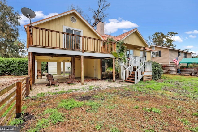 back of property with a wooden deck