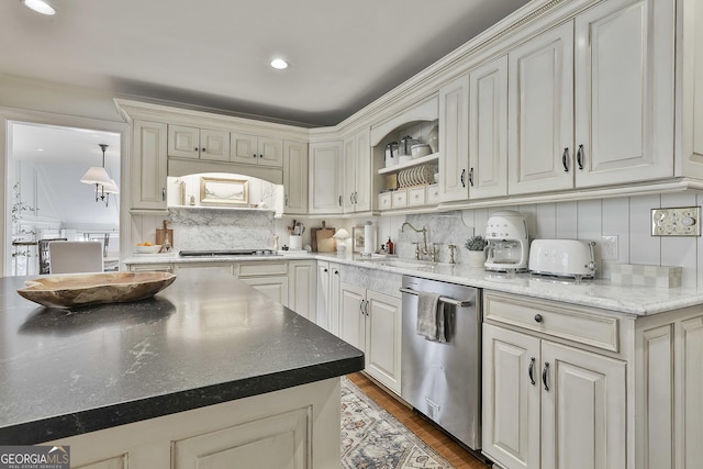 kitchen with sink, backsplash, dark stone counters, stainless steel appliances, and dark hardwood / wood-style flooring