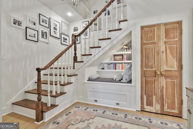 staircase with wood-type flooring