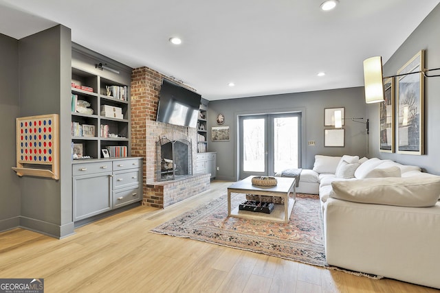 living room featuring a fireplace and light hardwood / wood-style flooring