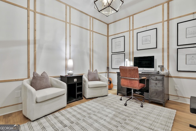 office area featuring light hardwood / wood-style floors and a notable chandelier