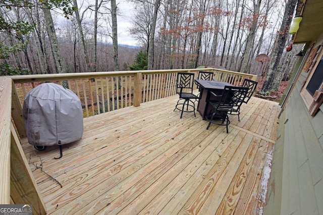 wooden terrace featuring a grill