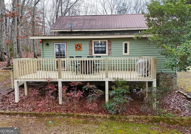 back of property featuring a wooden deck