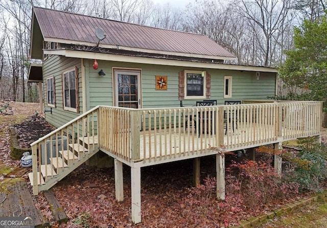 back of house with a deck