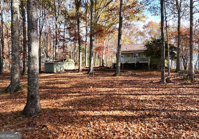 view of yard with a storage unit and a wooden deck